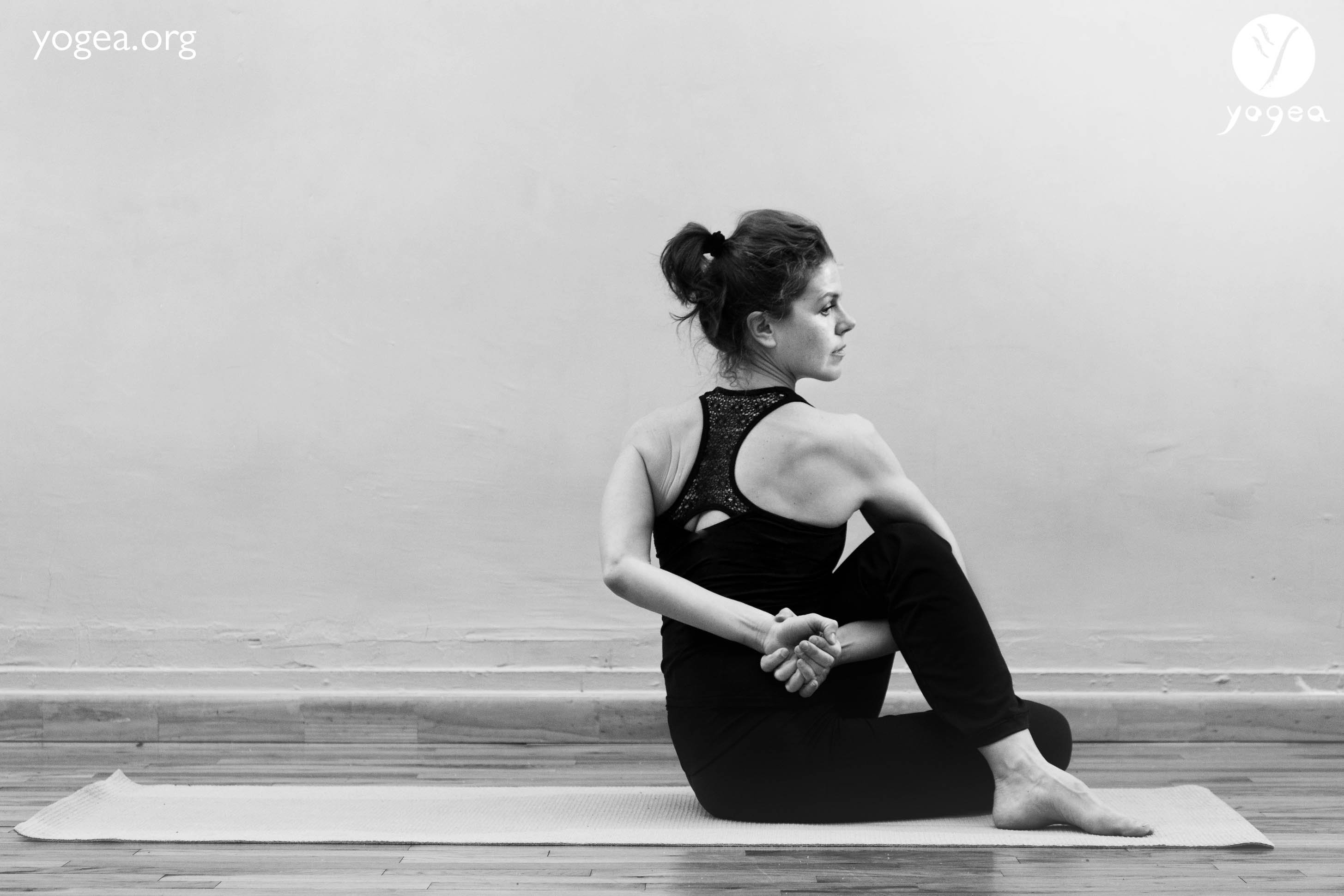 Woman In Seated Spinal Twist Yoga Pose
