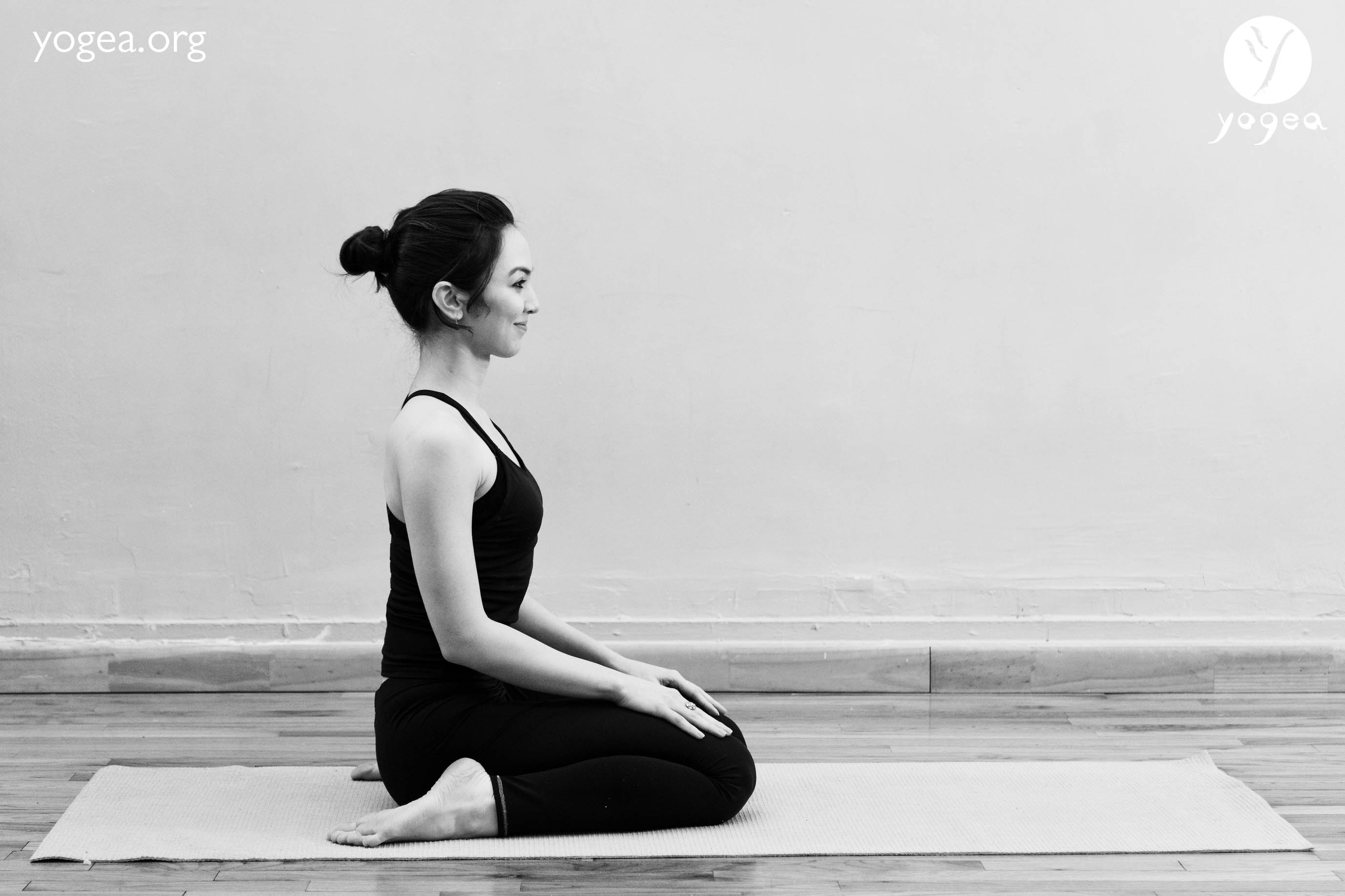Premium Photo | Woman athlete in yoga posture virasana or hero pose playing  a tibetan singing bowl